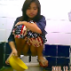 A very pretty Thai girl is recorded by a hidden camera as she takes a highly visible, large shit while squatting over a public floor toilet. She uses a bowl of water to flush and clean herself. About a minute.
